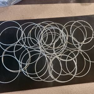 Bangles and more silvertone bangles.  25 +